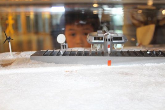 Young boy looks at the model of Princess Elisabeth Antarctica Station during the UK Polar Network / IPF Sea Ice, Shackleton and Science at Birmingham Thinktank