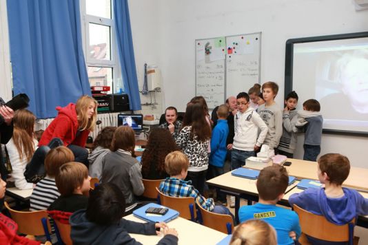 Kids at Ecole du Centre de Woluwe-Saint-Pierre wait to ask the doctor Jacques Richon a question.