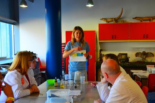 Maddy Brasier explains the outcome of an ocean acidification experiment to workshop visitors on Sunday