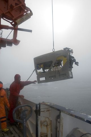 Jan Seiler from Germany, receives the ROV, the autonomous submarine vehicle with a video camera as it comes out of the water