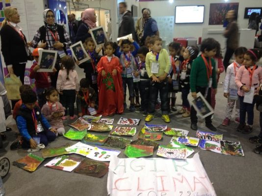 Nursery childre display their pictures and sing 