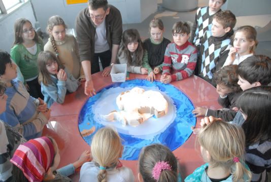 Students listening to a presenter as he talks about Antarctica. Afterwards, he will disassemble the puzzle and ask the students to put it back together again.