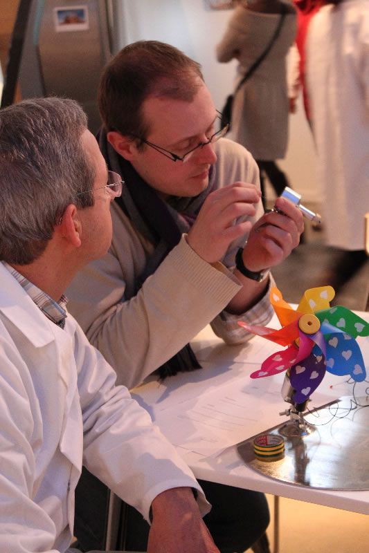 Teachers constructing a pinwheel that converts mechanical energy into electrical energy.