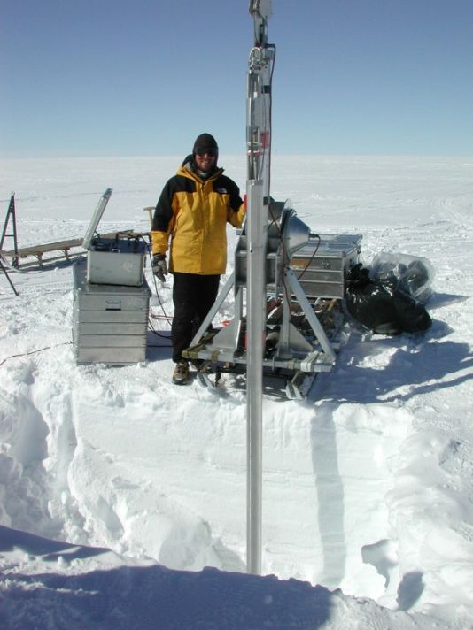Deep core drilling into hard ice, and perhaps underlying bedrock, involves using a hollow drill which actively cuts a cylindrical pathway downward around the core.