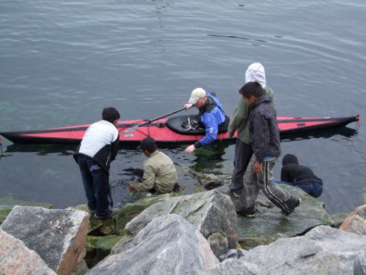 Catching capelin (small fishes) with the kids in Uummannaq harbour.