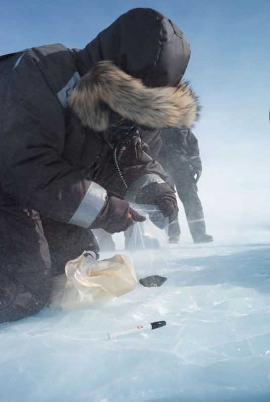 Scientists of the SAMBA team, sampling a meteorite they just found.